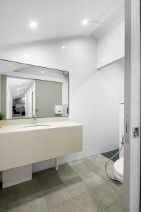 a bathroom with a large mirror and a sink at Circular House in Singapore