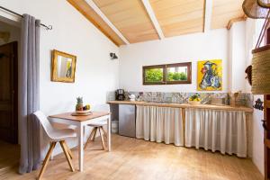 a kitchen with a counter and a table and chairs at Finca Can Paulino in Llucmajor