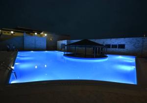 a large swimming pool lit up at night at Palm Beach Hotel in Anaklia