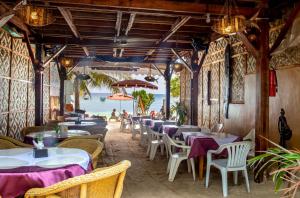 a restaurant with tables and chairs and a view of the ocean at Hayahay Resort in Panglao Island