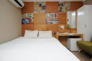 Postel nebo postele na pokoji v ubytování Hotel MIDO Myeongdong