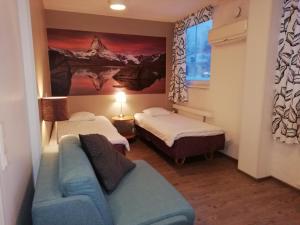 Un pat sau paturi într-o cameră la Hotel Turistihovi