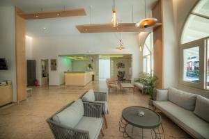 a living room with couches and a table at Hotel Alkionis in Moraitika