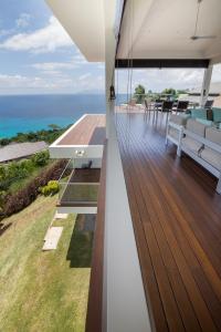 an open deck with a view of the ocean at AquaBlu Villa in Victoria