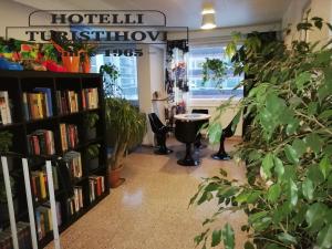 a bookstore with a book shelf filled with books at Hotel Turistihovi in Kouvola