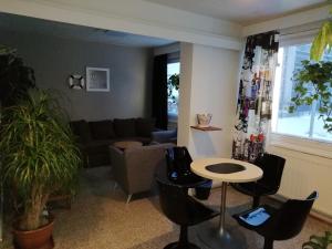 a living room with a couch and a table and chairs at Hotel Turistihovi in Kouvola