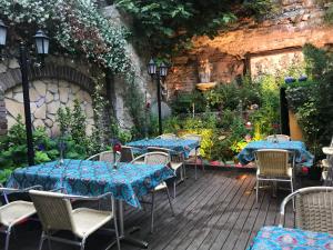 a patio with tables and chairs in a garden at Sphendon Hotel in Istanbul