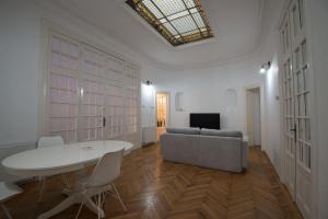 ein Wohnzimmer mit einem Tisch und einem Sofa in der Unterkunft George Enescu Suites in Bukarest