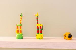three toy giraffe figurines sitting on a shelf at 曉翠軒親子民宿 in Wujie