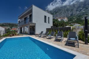 a villa with a swimming pool and a house at Villa Smart in Veliko Brdo
