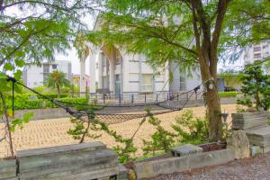 a hammock tied to a tree in front of a building at 曉翠軒親子民宿 in Wujie