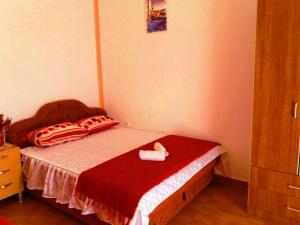 a small bedroom with a bed with a red blanket at Apartments Sun Igalo Montenegro in Igalo