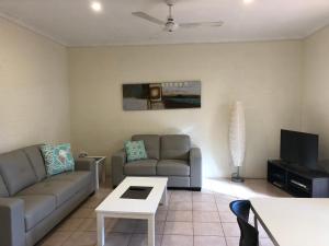 a living room with a couch and a tv at Pelican's Nest in Kalbarri