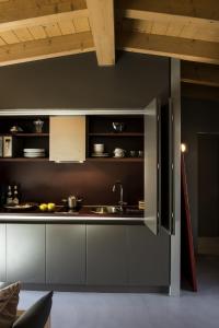 a kitchen with gray cabinets and a sink at Vivere Suites & Rooms in Arco