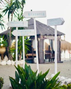 a group of signs in front of a resort at Gran Hotel Guadalpín Banus in Marbella