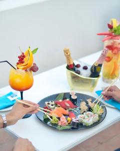 a table with a plate of food and a drink at Gran Hotel Guadalpín Banus in Marbella