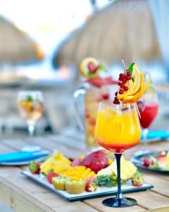a drink on a table with a plate of food at Gran Hotel Guadalpín Banus in Marbella