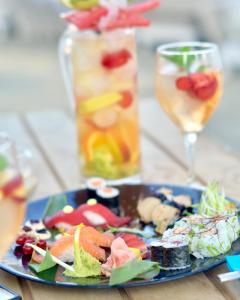 a blue plate of food on a table with a drink at Gran Hotel Guadalpín Banus in Marbella