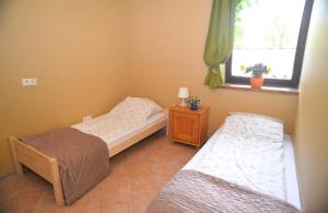 Postel nebo postele na pokoji v ubytování Apartament Poddąbie