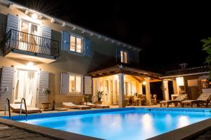 a swimming pool in front of a house at night at Villa Histria Relax in Svetvinčenat