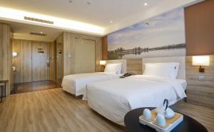 Ένα ή περισσότερα κρεβάτια σε δωμάτιο στο Atour Hotel Xi'an Gaoxin Tangyan Road Branch +3 φωτογραφίες