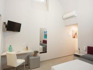 a white living room with a desk and a couch at Campanili di Puglia B&B in Andria