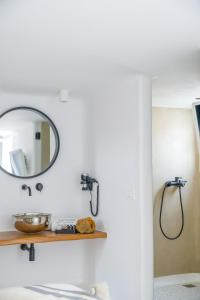 a bathroom with a mirror and a sink at Euphoria Chora Naxos in Naxos Chora