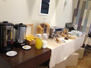 a buffet with food and drinks on a table at Cosmopolit in Athens