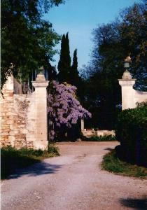 einen Eingang zu einem Haus mit lila Blumen in der Unterkunft Les Esclots , Nîmes, Gîtes 4 personne in Générac