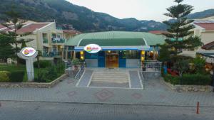 a building with a sign on the front of it at Belcehan Hotel in Oludeniz