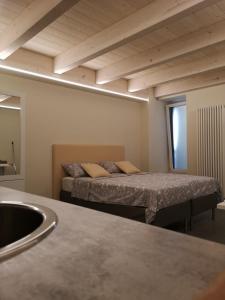 a room with two beds and a sink in it at Vico-Letto studio apartment in Guardiagrele