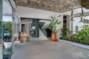 an indoor lobby with potted plants and a ceiling at Vincci Selección Posada del Patio in Málaga