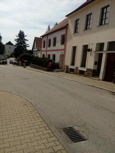 una calle vacía con casas a un lado de la carretera en ubytování u Hradu, en Nové Hrady