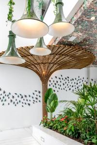 a group of lights hanging from a ceiling with plants at Vincci Selección Posada del Patio in Málaga
