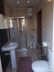 a bathroom with a shower and a sink and a toilet at Bugibba Homes Suite in St Paul's Bay +21 photos