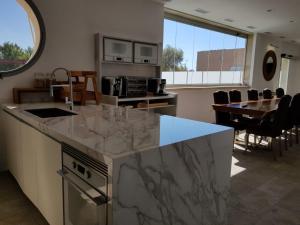 a kitchen with a marble counter top and a dining room at Villa Rainbow Home Mallorca in Palma de Mallorca