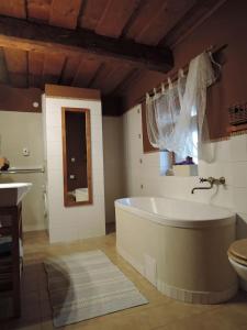 a large bathroom with a tub and a sink at Drevenica Inga in Staré Hory