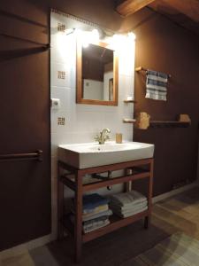 a bathroom with a sink and a mirror and towels at Drevenica Inga in Staré Hory +41 photos