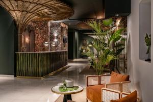 a lobby with a couch and a table at Vincci Selección Posada del Patio in Málaga