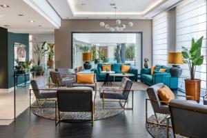a living room with blue couches and chairs at Vincci Selección Posada del Patio in Málaga