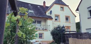 a large white house with a black roof at Boardinghouse Leiwen 46 in Leiwen