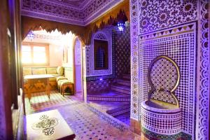 a room with a purple room with a tub in it at Riad Mehdi Meknès in Meknès