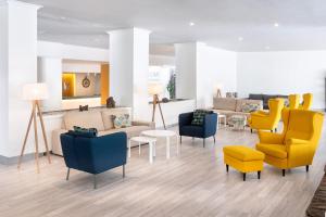 a waiting room with yellow and blue chairs at Sol Puerto de la Cruz Tenerife in Puerto de la Cruz