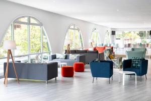a living room with couches and chairs and windows at Sol Puerto de la Cruz Tenerife in Puerto de la Cruz