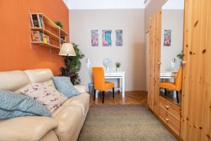 a living room with a couch and a desk at Pesto private rooms in Budapest