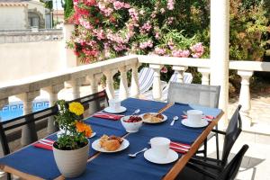 een blauwe tafel met borden eten op een balkon bij Guti in L'Escala