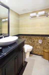 a bathroom with a sink and a toilet at Golden Boutique Hotel Melawai in Jakarta