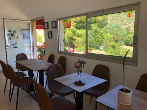 a restaurant with tables and chairs and a large window at Stella Marina in Galeria