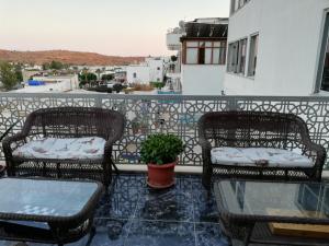 two chairs and a table on a balcony at Mavi Yeşil Yaşam Hotel in Gümbet