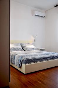 a bedroom with a bed with a blue blanket at Appartamento Giuliana Cervia in Cervia